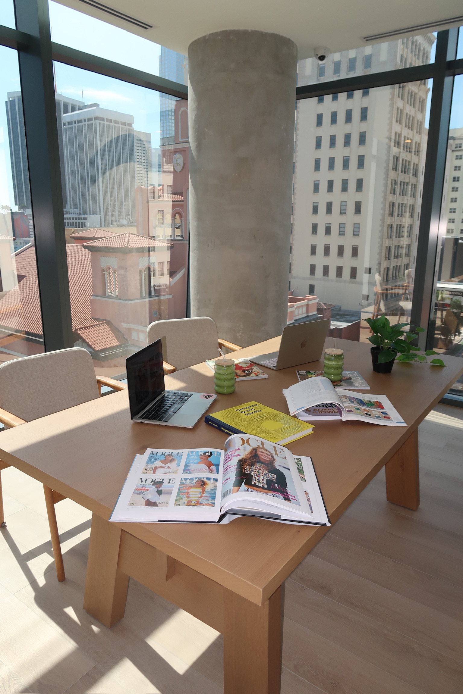 Casa workspace with fashion books, laptops and city views