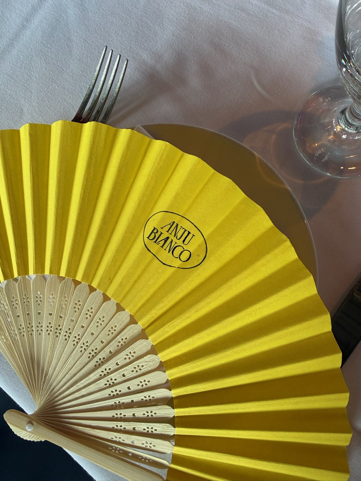 Yellow Anju Blanco fan on the launch-brunch table