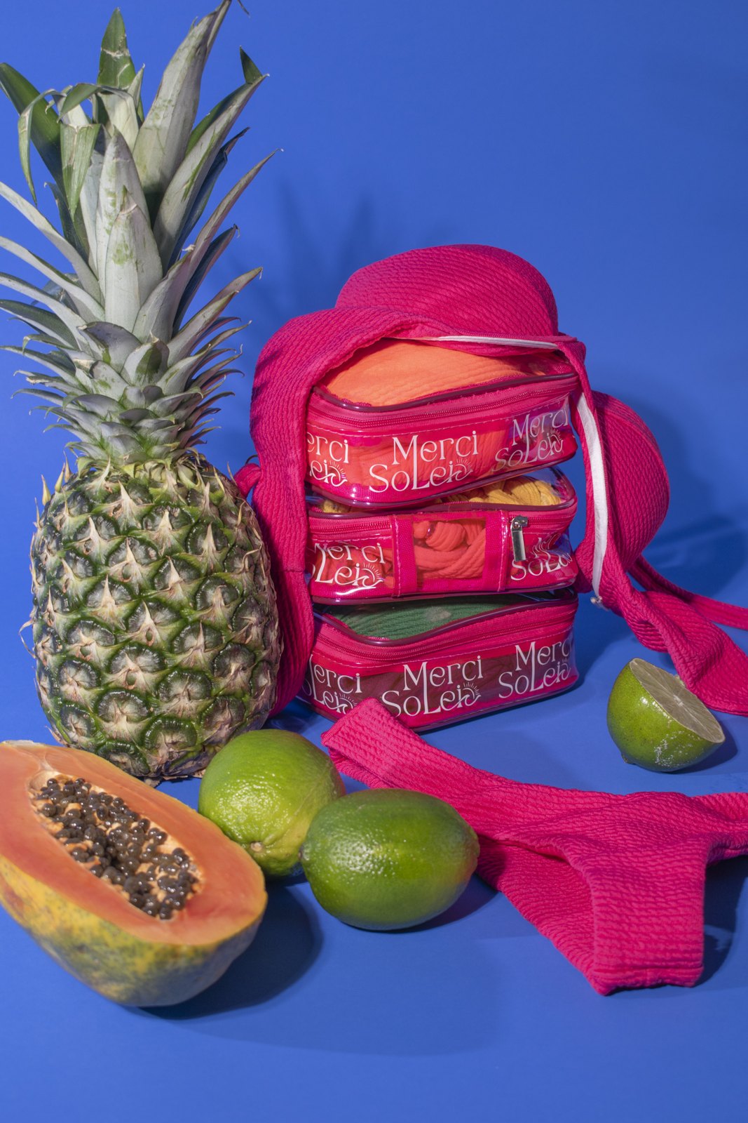 Merci Solei pink accessories styled with tropical fruit